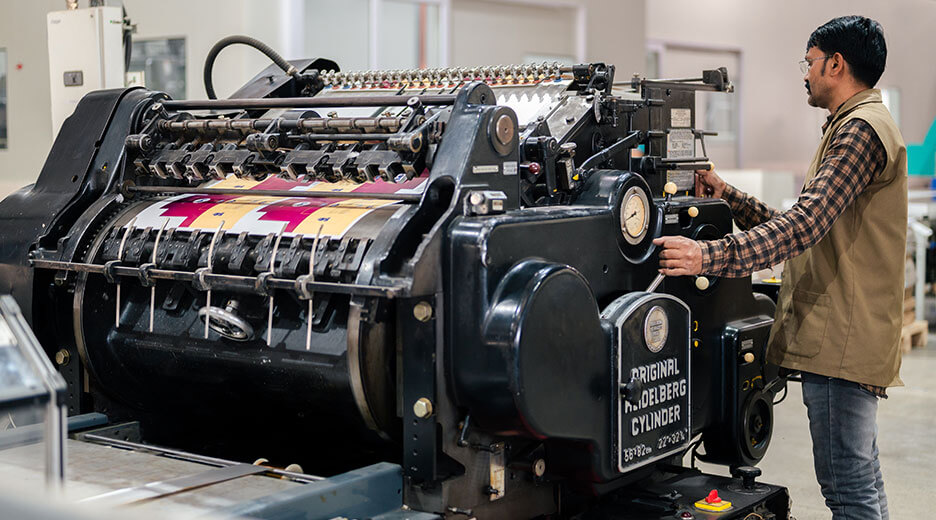 A man is checking to box packaging printing 