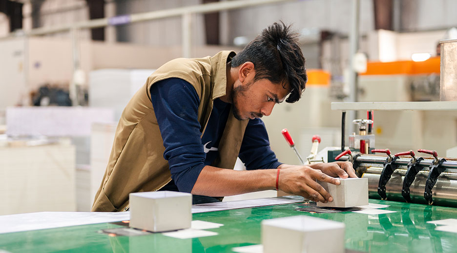 A men is working on printing packaging  in AMBA offset production unit